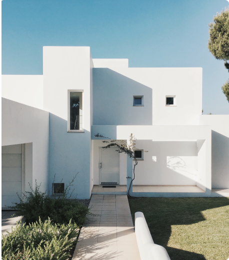 Modern white house with contemporary architecture showcasing our real estate expertise